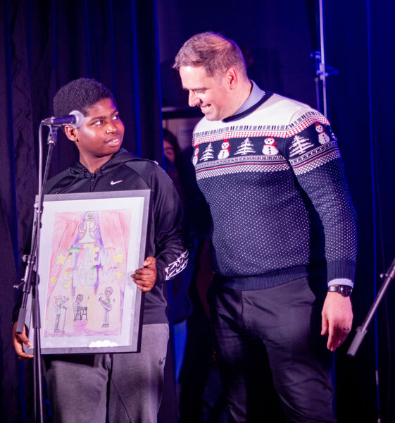  first year student Joseph Bello, who designed the Talent Show poster received a presentation from Mr. Baily, at the St. Paul's Community College, Spotlight Talent Show. Photo: Joe Evans