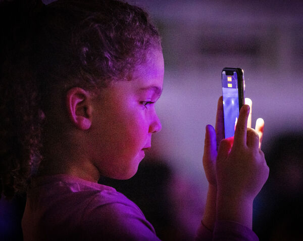  Recording her big sister Shanice, on stage as she performed Girl on Fire, at the St. Paul's Community College, Spotlight Talent Show. Photo: Joe Evans