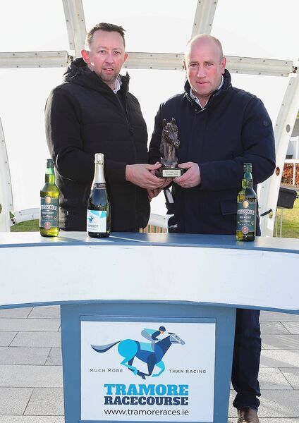 Andrew Ryan from sponsors Ryans Cleaning Services is pictured presenting the winner's prize to Ian Amond from the Gordan Elliott stable after their horse American Jukebox won the the Ryans Cleaning Services Maiden Hurdle.