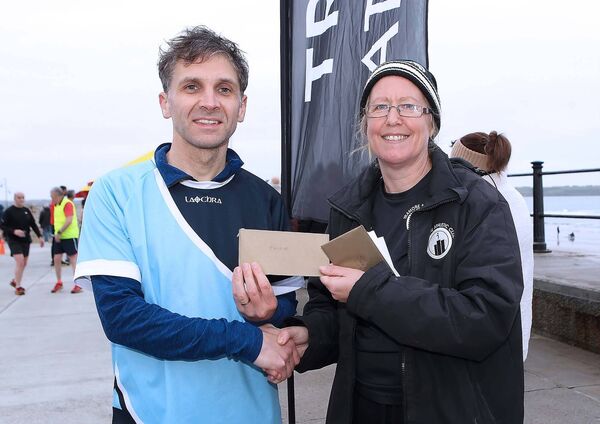 Nora Storey, Chairperson, Tramore AC presents the Men's Baldy Man Run winner Dermot Gorman, Carrick AC with his prize. Nora Storey, Chairperson, Tramore AC presents the Men's Baldy Man Run winner Dermot Gorman, Carrick AC with his prize.