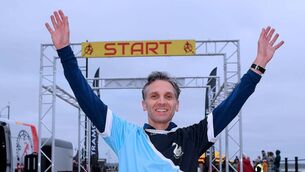 <p>Dermot Gorman, Carrick AC, crosses the line to win the 2025 Baldy Man Run men's winner.</p>