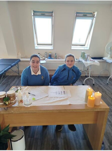 Students working at reception in the beauty salon.