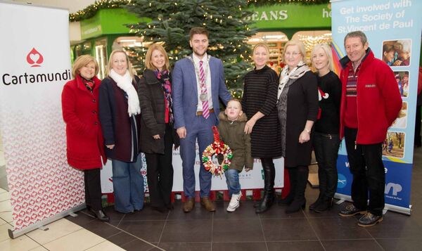 Former Mayor of Waterford Cllr Adam Wyse pictured with Lisa and Kathleen Fitzgerald, centre right, at the launch of the Giving Tree some years ago. The Giving Tree was a feature of Christmas in George's Court for many years.