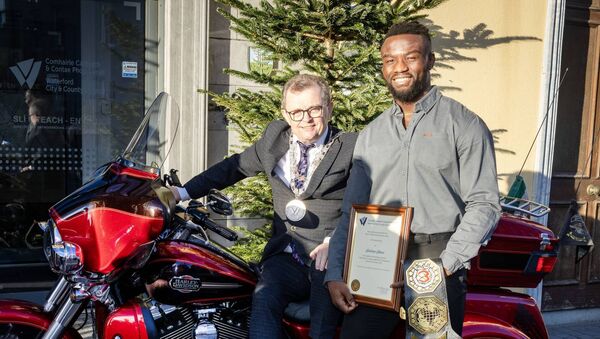 Mayor Ryan and Simon pictured beside a Harley-Davidson- the motorcycle manufacturer that sponsors Simon.  Photo: Joe Evans 