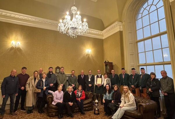Family friends and bandmates of James Stone gather with Mayor Seamus Ryan to celebrate the pipe players phenomenal year. 