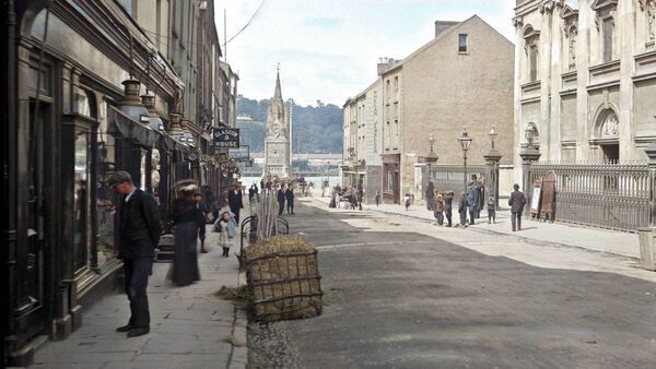 c1890, Window Shoppers Waterford's busy Barronstrand Street snapped by the legendary Robert French. Window shoppers admire the wares, the Catholic Cathedral, designed by Honest John Roberts, looms large behind, while the Clock Tower quietly marks minutes, now long-since passed. Funny how some things have changed so much, but other things haven’t changed at all. 