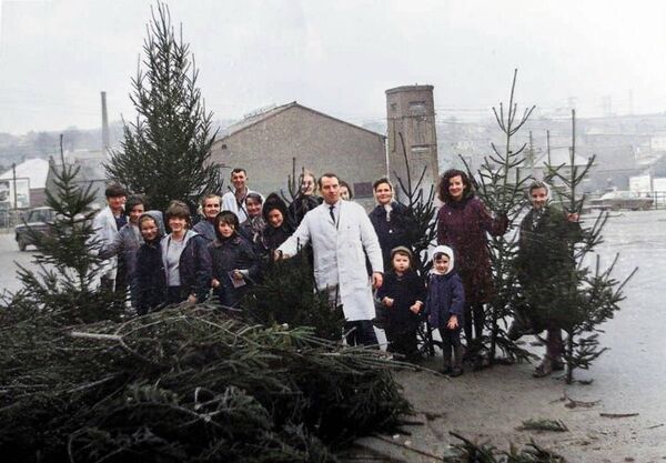 1967, Christmas on Ballybricken Freddie Kervick stands proudly with his delivery of Christmas trees on Ballybricken, Waterford, surrounded by families eager to bring home their festive centrepiece. A great sense of community spirit in 1960s Waterford, with the Denny's chimney visible in the background, birthplace of the humble yet all-powerful rasher. 