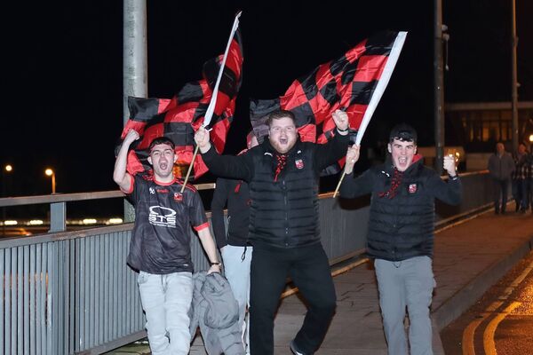 Ballygunner fans celebrate the win on Rice Bridge as they await the teams return. 