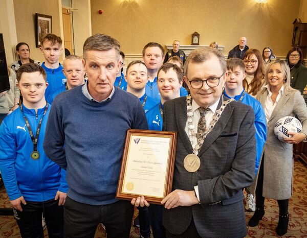 Colin Power pictured accepting the scroll on behalf of the club. Photo: Joe Evans