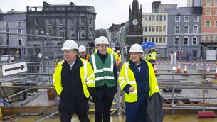 <p>L-R: Minister for Transport Darragh O'Brien, Minister for Local Government and Planning John Cummins, Minster for Mental Health Mary Butler walk across the North Quays' sustainable transport bridge. Photo: Patrick Browne</p>