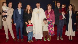 <p>Permanent Deacon David Cooney with family members. Photo: John Power</p>