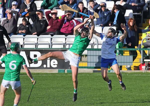 Waterford's Jamie Barron in an aerial duel with Limerick's Diarmuid Byrnes.