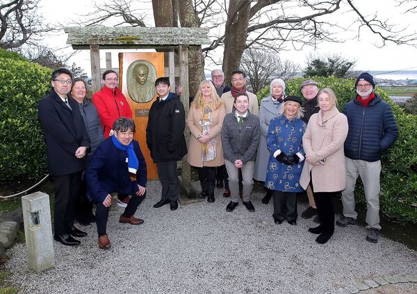 The delegation pictured at the bust of Lafcadio Hearn