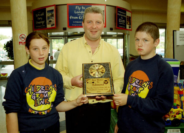  Tesco Poleberry, held their second annual barbecue, raising in excess of £1,400 for Children's Group Link, pictured presenting a clock to show their appreciation to the General Manager of Tesco Poleberry, Edmund Dick, are Catriona Collins and Jamie Stephens, Childrens Group Link back in 2000.