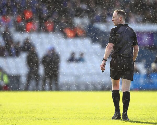 Dublin referee Chris Mooney pictured during a shower of rain in Waterford's clash with Offaly at Walsh Park. 