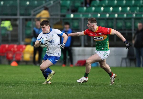 Waterford's Darach ÓCathasaigh tries to get away from the challenge of Dara Curran from Carlow.