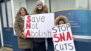 <p>Eleanor McCartney, Roisin Ryan and Piper Ryan pictured protesting outside of Waterford Minister of State John Cummins' office.</p>