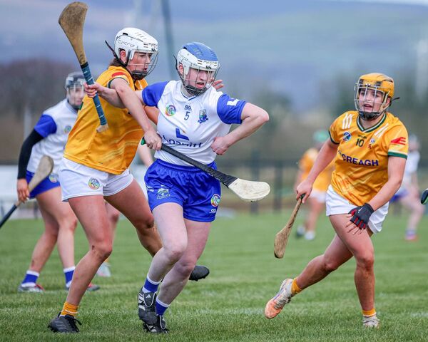 Waterford's Rachael Walsh bursts out with possession under pressure from Antrim's Aimee Ferris.