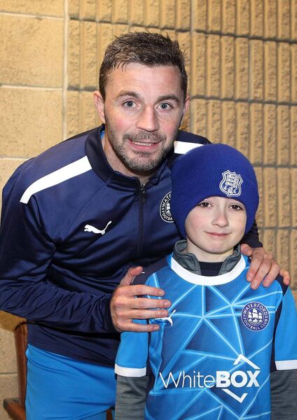 Waterford FC captain Padraig Amond pictured with mascot Louis Fetat, St. Joseph's FC, before the game against Bohemian FC.