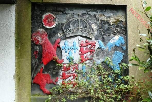 A plaque in the building's exterior courtyard. Planning reports recommend that it be repaired and repainted