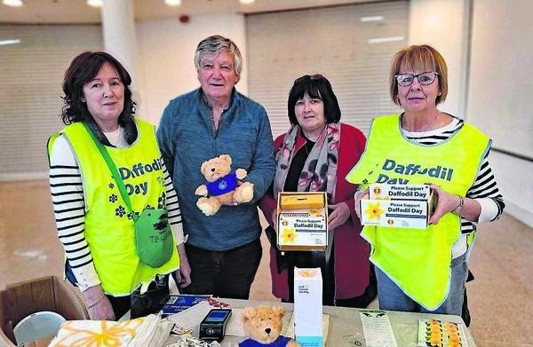 Daffodil Day volunteers Marie Power, Alice Purcell and Eileen Gallagher with David Palmer, raising money for the Irish Cancer Society on Friday. 	All Photos: John Power