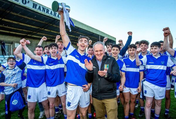 Mount Sion captain Bradley Penkert lifts the cup after it is presented by Noel Delaney from the Leinster Council.