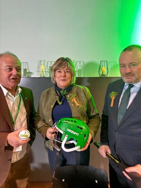 Minister Butler showcases hurling helmets by Azzuri Waterford at the Irlande Tourism Expo in Madrid