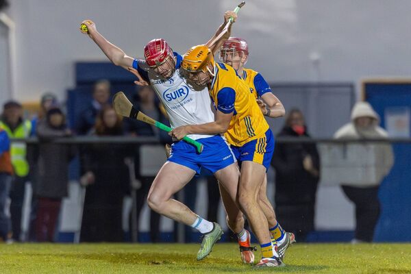 Waterford's Pat Walsh tries to get past the challenge of Clare's Robert Loftus. Waterford's Pat Walsh tries to get past the challenge of Clare's Robert Loftus.