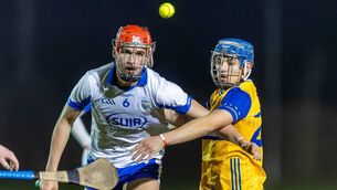 <p>Waterford's Joe McDonnell and Clare's Paul Rodgers have their eyes on the ball during their clash.</p>