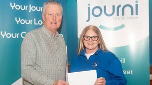 <p>Mary Condon of Waterford Marine Search &amp; Rescue accepting a donation from Journi Credit Union, presented by Tim O’Byrne. </p>