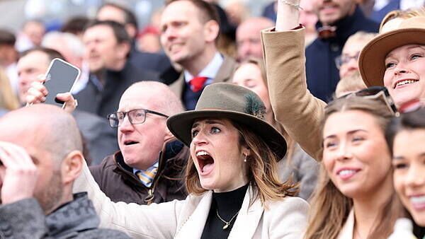 Crowds cheer on as Grand National winner crosses the line