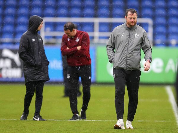 Waterford FC's manager Jon Daly leaves the pitch as officials decide to postpone the game against Drogheda.
