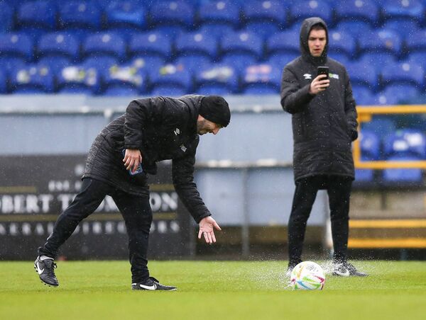 Daryl Carolan performs a ball bounce during the pitch inspection as Shane O'Brien videos the inspection.