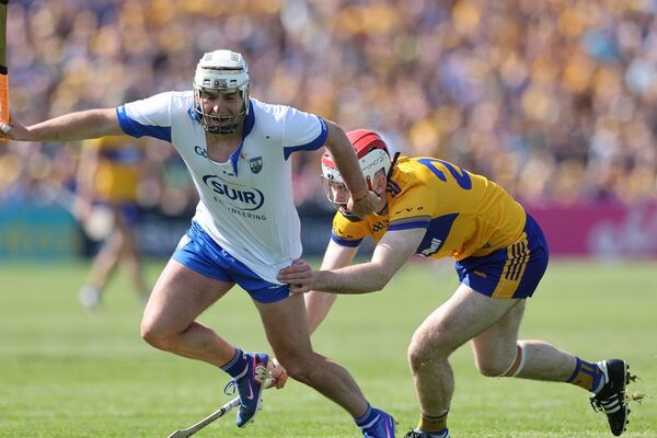 Dessie Hutchinson of Waterford is tackled by Conor Leen of Clare.