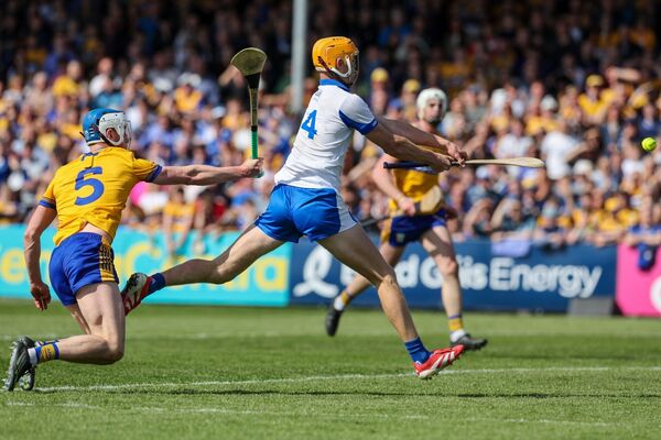 Sean Walsh of Waterford scores a goal against Diarmuid Ryan of Clare
