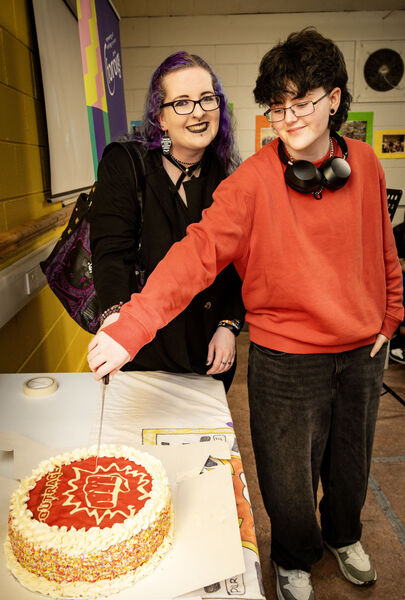  Original and present members of Outrage, Samantha Cullen and Austin Robinson, cut the cake at the 25th anniversary celebrations.