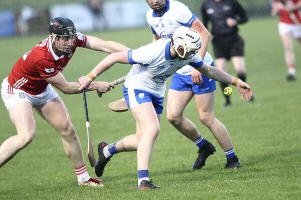 Waterford's Cathal O'Sullivan wins possession ahead of Cork's Zach Biggane.
