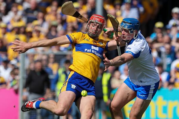 Clare's Peter Duggan tries to get past the challenge of Waterford's Aaron O'Neill.