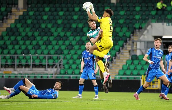 Waterford FC goalkeeper Arlo Doherty comes to win this ball under pressure from Rovers' Michael Noonan.