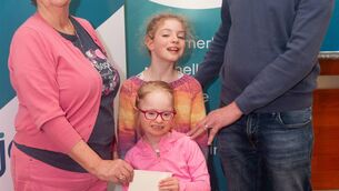 <p>Linda O’Kane of Journi Credit Union is pictured presenting a donation to the Sunny South East Cycle, accepted by John Byrne, who is pictured with his daughters, Aoibhe and Jamie. </p>