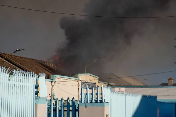 Flames and heavy smoke can be seen issuing from the roof of Tycor Business Centre. 	Photo: Rory Casey