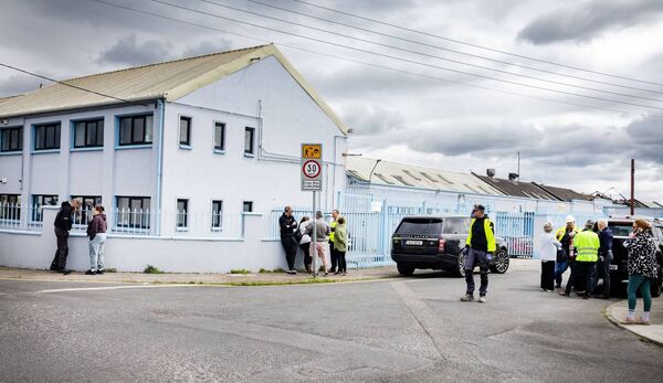 Business owners gather at the scene of Saturday's fire that ripped through the Tycor Business Centre. Photo: Joe Evans