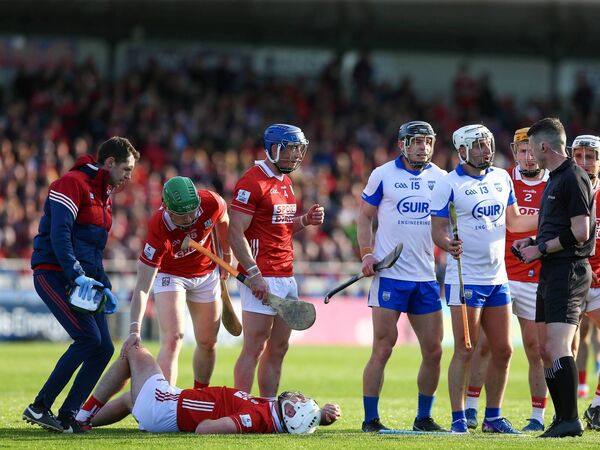 Waterford's Dessie Hutchinson appeals to Sean Stack as Cork's Tim O'Mahony lays injured. Waterford's Dessie Hutchinson appeals to Sean Stack as Cork's Tim O'Mahony lays injured.
