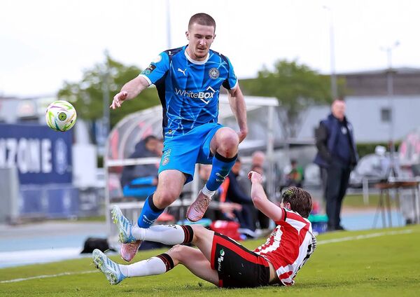 Waterford FC's Will Johnson hurdles the tackle from Derry City's Brandon Fleming. Waterford FC's Will Johnson hurdles the tackle from Derry City's Brandon Fleming.