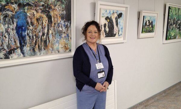 Nurse and artist Marley Irish retires from UHW after 43 years. Pictured in front of her exhibition at the hospital, 'Returning Home'.