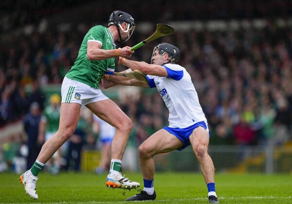 Limerick's Gearoid Hegarty is tackled by Waterford's Mark Fitzgerald as he makes his way towards goal.