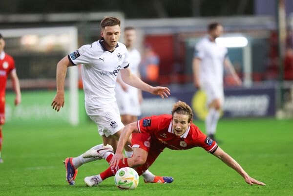 Waterford FC's Hayden Cann in a challenge with Shelbourne's Harry Wood during their league clash.