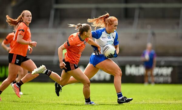 Waterford's Maeve Daly bursts forward with the ball closely followed by Armagh's Grace Ferguson.