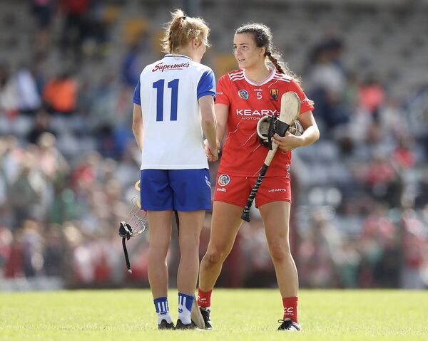 Cork’s Ava Fitzgerald and Waterford’s Beth Carton shake hands at the final whistle.