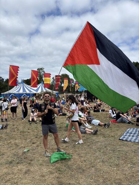  Bahaa Alkayyali waving his flag at the peace concert in support of Palestine